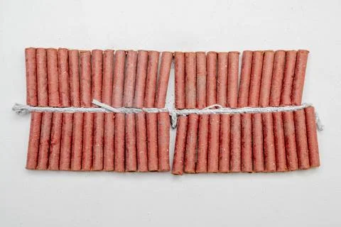 Red fire crackers string isolated over white background Fotos Stock