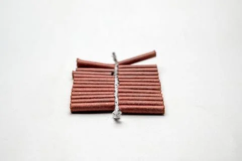Red fire crackers string isolated over white background Foto stock