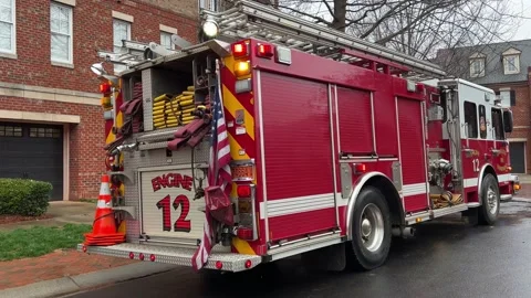 Red Fire Engine with flashing red lights reflecting on a wet road Stock Footage 232053422
