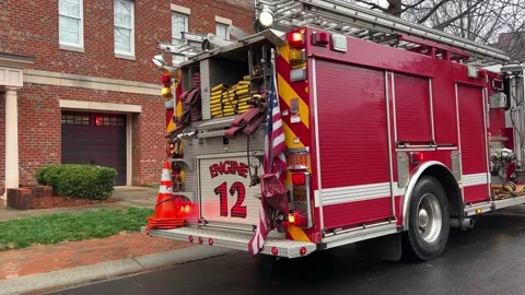 Red Fire Engine with flashing red lights reflecting on a wet road Stock Footage 232053454
