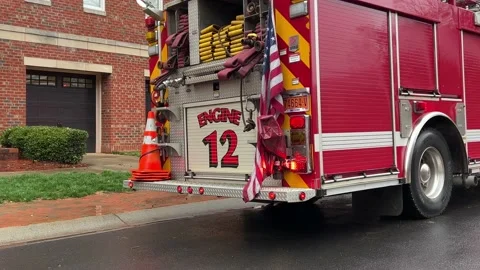 Red Fire Engine with flashing red lights reflecting on a wet road Stock Footage 232053482