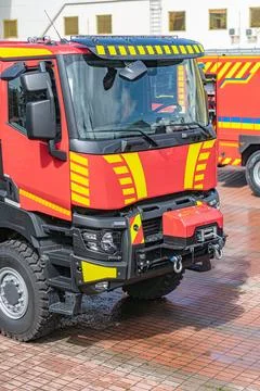 Red fire engine parked on a brick pavement, multiple emergency lights, large  Stock Photos
