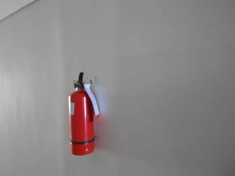 Red Fire Extinguisher Mounted on Wall in Building Corridor Photos