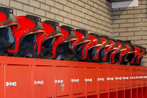 Red fire helmets placed in a row Stock Photos
