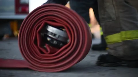 Red fire hose being rolled up Vidéo 50222649