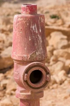 Red fire hydrant on the background of the stones Foto stock