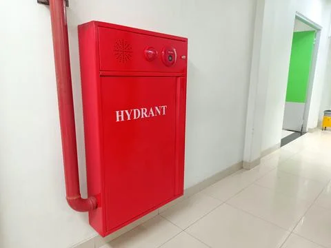 A red fire hydrant box installed in the corridor of a hospital. Stock Photos