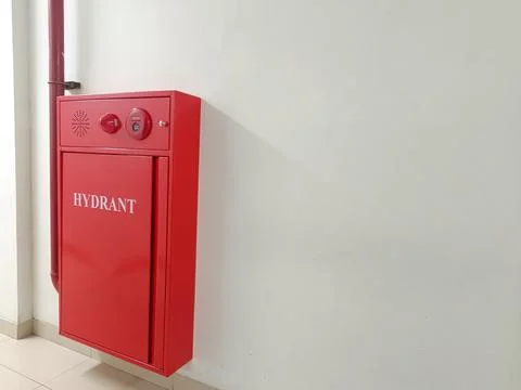 A red fire hydrant box installed in the corridor of a hospital. Stock Photos