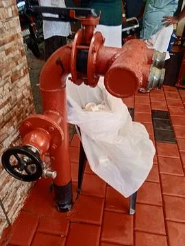 Red fire hydrant on brick floor Fotos Stock