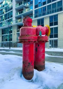 Red fire hydrant on city sidewalk near modern building Stock Photos