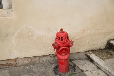 A Red Fire Hydrant in Front of an Old Wall in Venice Stock Photos