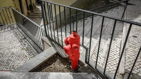 Red fire hydrant in the paved streets of Lisbon Photos