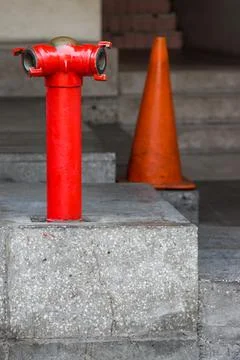 Red Fire Hydrant Pillar with Metallic Chain on Concrete Sidewalk and Green .. Stock Photos