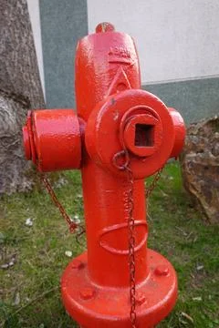 Red fire hydrant providing emergency water supply outdoors Foto stock