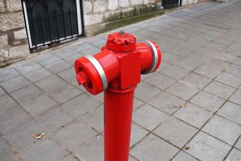 Red fire hydrant on the sidewalk close-up Stock Photos