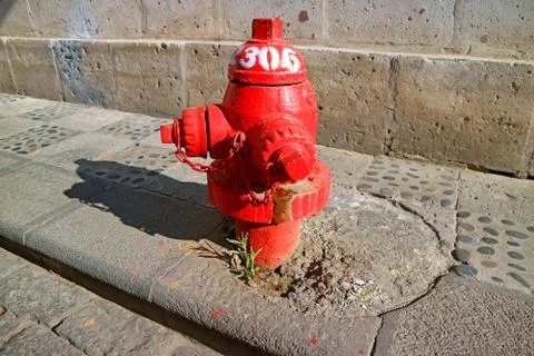 Red fire hydrant on the sidewalk of the old city of Arequipa, Peru Stockfoto's