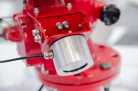 A red fire hydrant with a silver cap on top Stock Photos