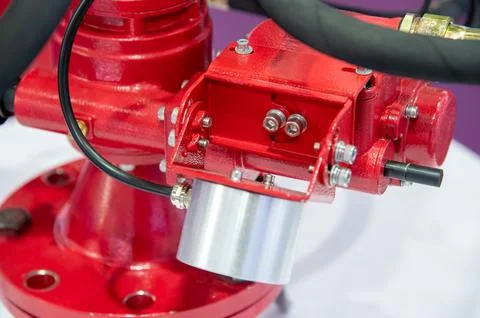 A red fire hydrant with a silver cap on top Stock Photos