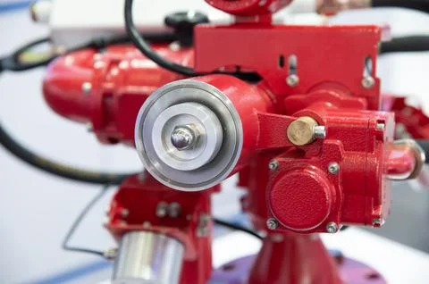 A red fire hydrant with a silver gear on it Stock Photos