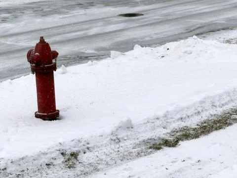 A red fire hydrant in the snow Stock Photos