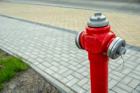 Red fire hydrant standing by the town footpath Stock Photos