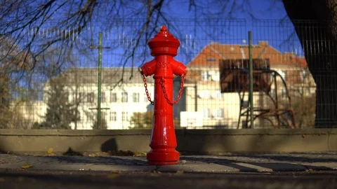Red fire hydrant on the street. People walk down the street. Clear autumn day Video stock 99005121