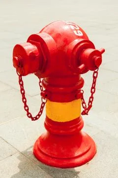 Red fire hydrant on the street Stock Photos