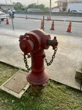 Red fire hydrant on urban sidewalk Stock Photos