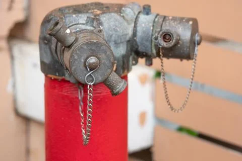 Red fire hydrant water pipe with a chain on the street Stock Photos