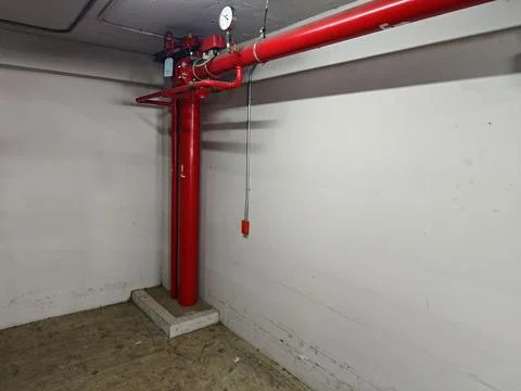 Red Fire Pump System in Empty Basement Industrial Space Stock Photos