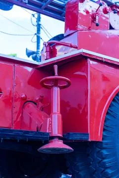 Red fire truck stabilizer jack with hand wheel for emergency vehicle support Stock Photos
