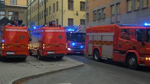 Red fire trucks with blue lights on respnd to emergency Stock Footage 123797904