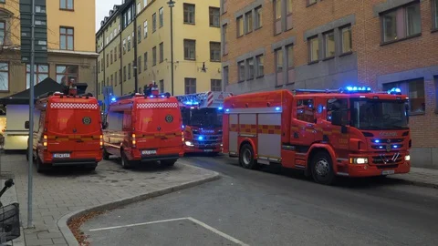 Red fire trucks with blue lights on respond to emergency Stock Footage 128941536