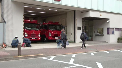 Red Fire Trucks Parked Inside a Tokyo Fire Station Garage Stock Footage 341852864
