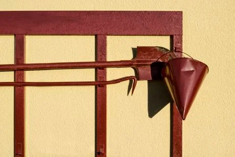 Red firefighter shield with spade hook and a cone of sand on a bright Sunny d Stock Photos