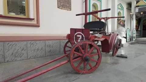 Red Firefighting Cart Marked Number Seven Stands Near a Lenin Bust Vídeos de archivo 340356025