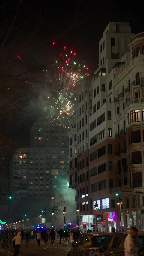 Red firework burst above Valencia buildings during Las Fallas la crema night Stock Footage 336856855