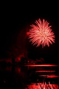 Red firework over a lake Stock Photos