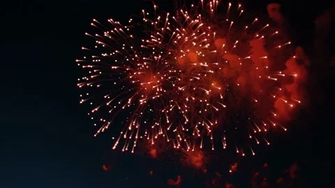 Red fireworks are visible from above, which explode with large red balls Stock Footage 232265063