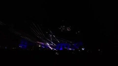 Red Fireworks Bursting through Smoke above Cinquantenaire Arch with Searchlight Stock Footage 341077499