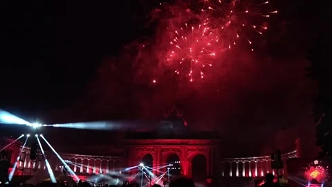 Red Fireworks Bursting through Smoke above Cinquantenaire Arch with Searchlight Stock Footage 341077527