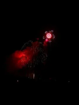 Red fireworks exploding in night sky at 22 July Cannes Фото