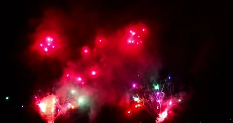 Red Fireworks Exploding Over Water at Night Video stock 342855564