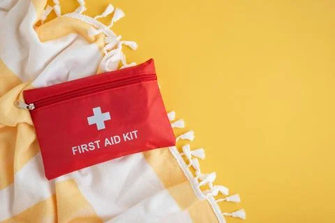 Red first aid kit for summer travel safety Stock Photos