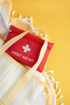 Red first aid kit for summer beach safety Stock Photos
