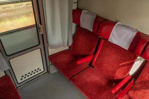 Red first class compartment in train with sunny shine in evening Stock Photos