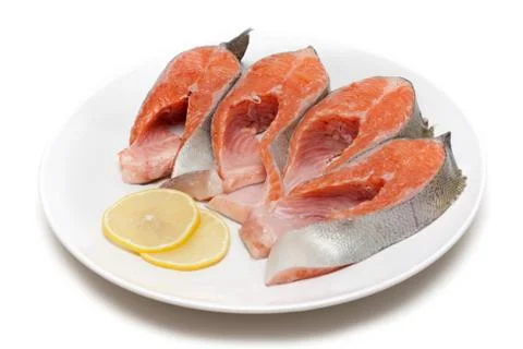 Red fish bit with lemon on plate Stock Photos