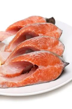 Red fish bit with lemon on plate Stock Photos
