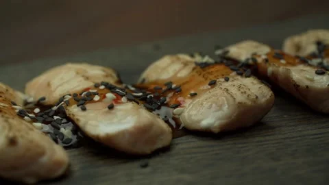 Red fish on a cutting board sprinkled with sesame seeds on top. Stock Footage 143196169