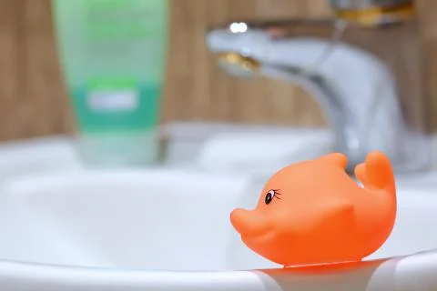 The red fish decorates the bathroom while sitting near the bathroom sink. Stock-Fotos